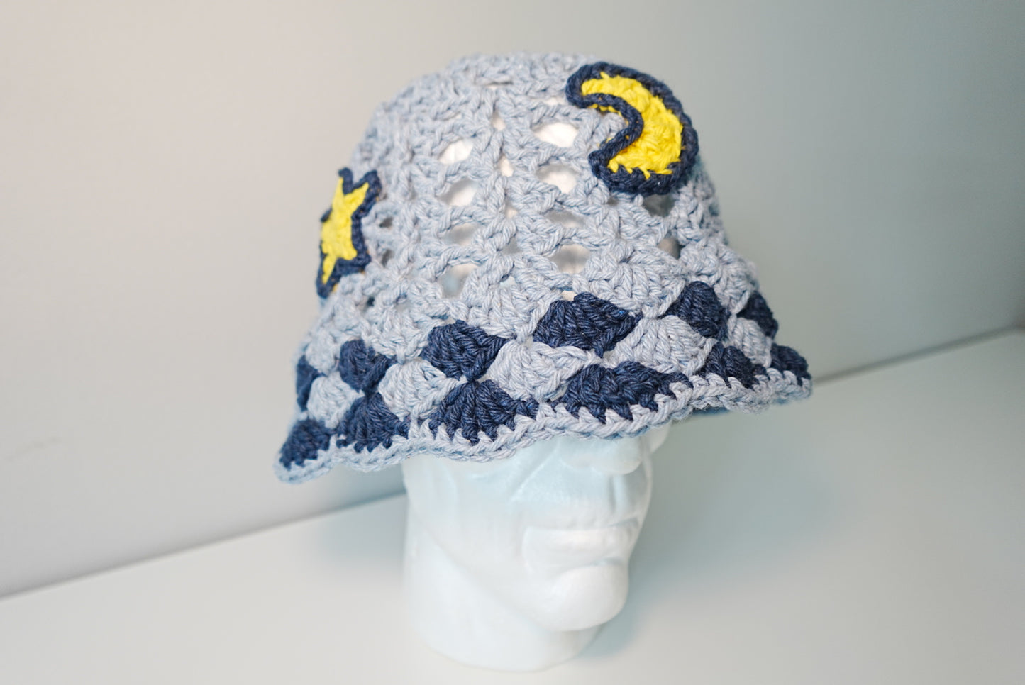 A Moon and Stars Crochet Hat in Denim Blue color